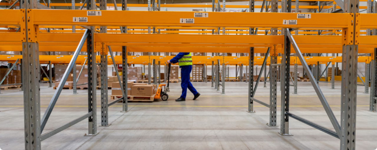 warehouse with worker pushing boxes